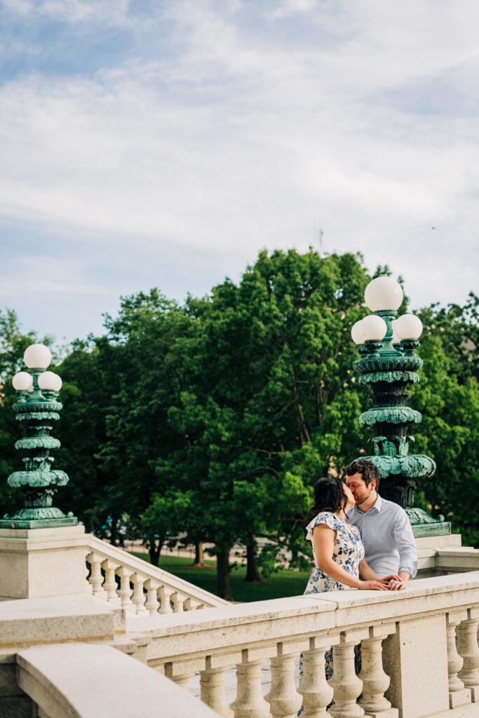 Couple sharing a quiet moment on the Capitol terrace overlooking the trees in downtown Madison.